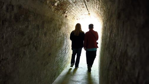Visitors walking through a tunnel at Bembridge Fort, Isle of Wight